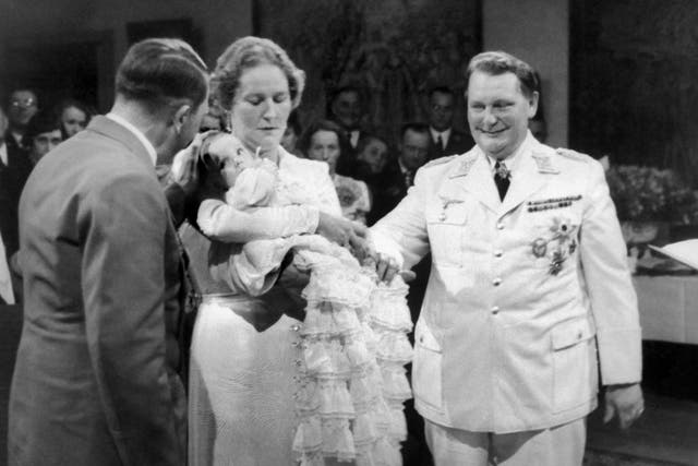 German nazi Chancellor Adolf Hitler (L) attends Hermann (R) and Emmy (C) Goering's daughter Edda baptism in Carinhall on November 4, 1938
