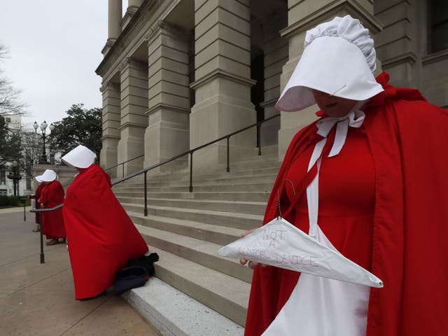 Georgia members of the Handmaid Coalition protest the passage of the 'fetal heartbeat bill' banning abortions after six weeks on International Women’s Day, 2019
