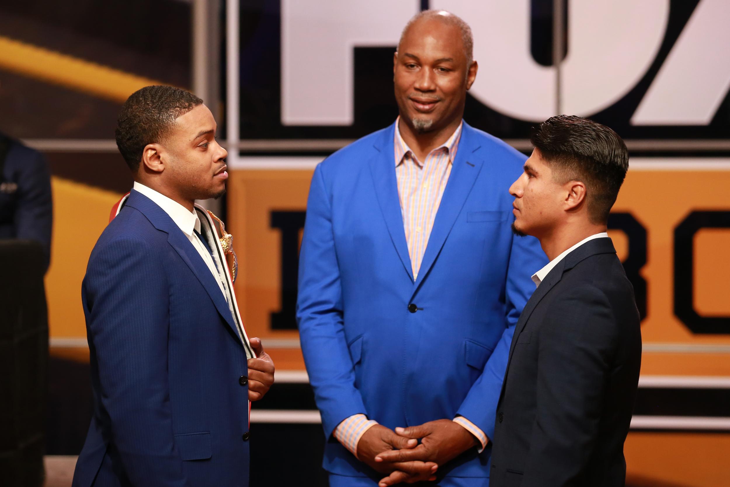 Spence and Garcia stare each other down as Lennox Lewis watches on (Getty)