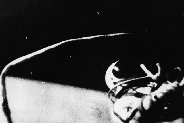 Russian astronaut Alexei Arkhipovich Leonov steps from the spaceship Voskhod 2 to become the first man to walk in outer space