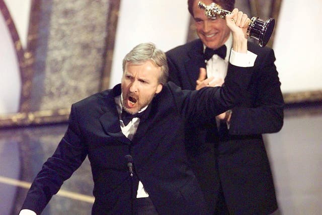 <p>Director James Cameron raises his Oscar after winning in the Best Director Category during the 70th Academy Awards at  Shrine Auditorium 23 March. Cameron won for his movie "Titanic."</p>