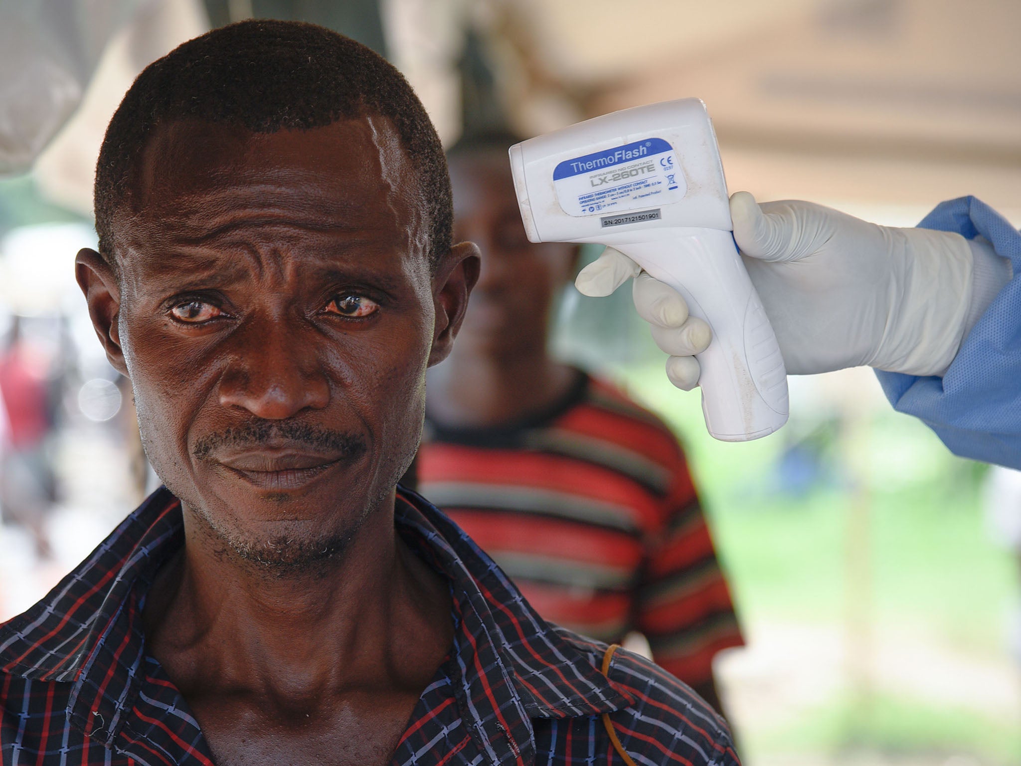 A man from DRC has his temperature checked by a non-contact thermometer at the Ebola screening point bordering with DRC in Mpondwe, western Uganda (AFP/Getty)