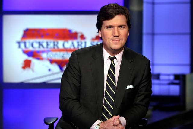 In this 2 March 2017 file photo, Tucker Carlson, host of "Tucker Carlson Tonight," poses for photos in a Fox News Channel studio