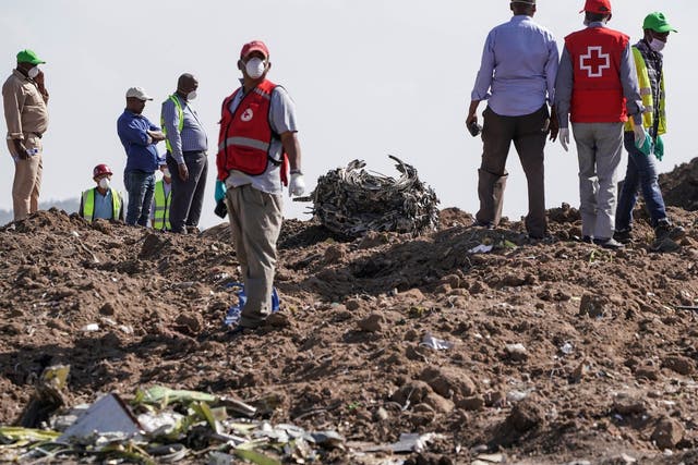 Recovery workers inspect an engine after it was recovered from the scene near Addis Ababa this week
