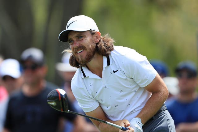 Tommy Fleetwood watches his drive on the ninth tee