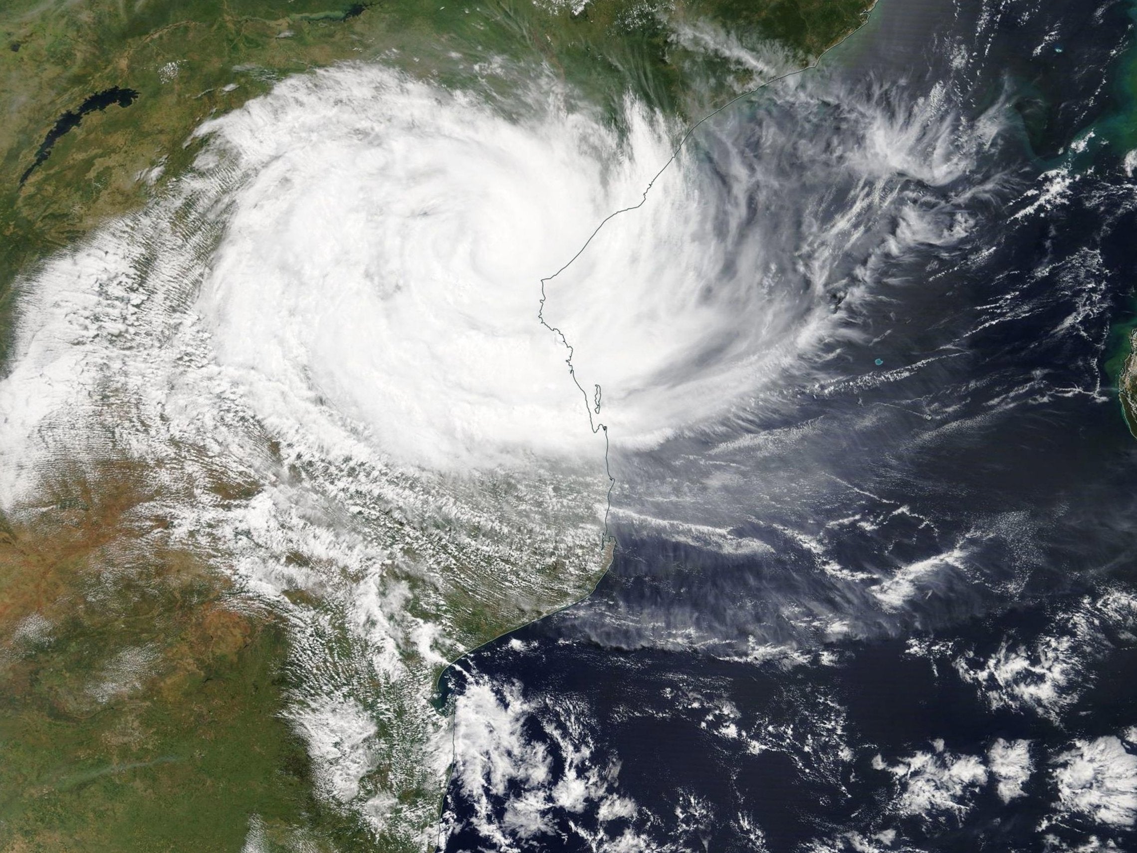 A handout photo made available by NASA showing cyclone Idai as it hits Mozambique