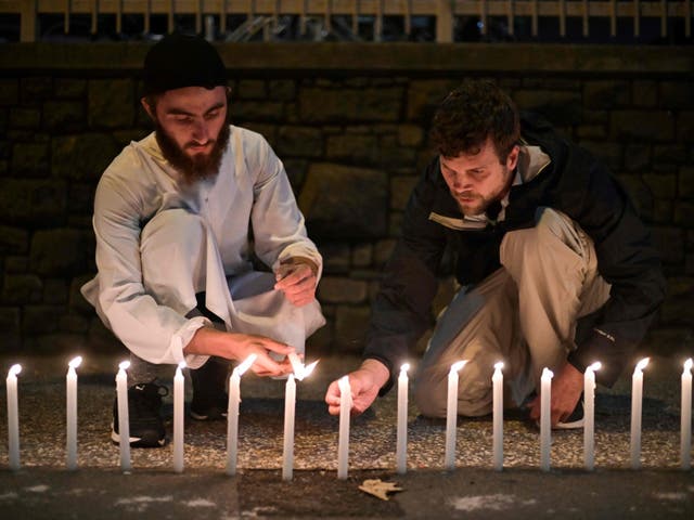 Well-wishers light 49 candles as they pay respects to victims outside the hospital in Christchurch