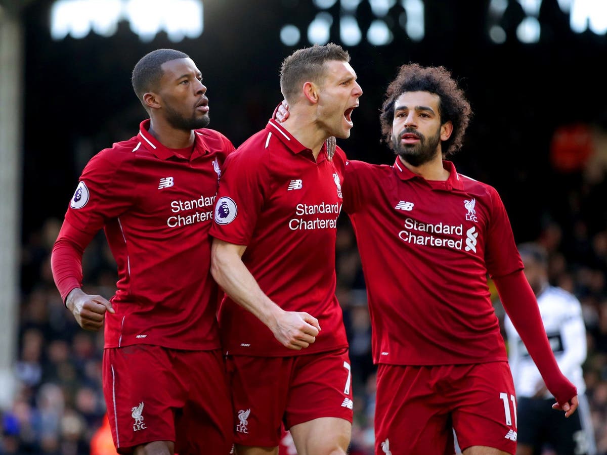  Liverpool's Mohamed Salah celebrates scoring his team's first goal with teammates Dejan Lovren and Fabinho during the Premier League match between Fulham FC and Liverpool FC at Craven Cottage on 31 March 2019.