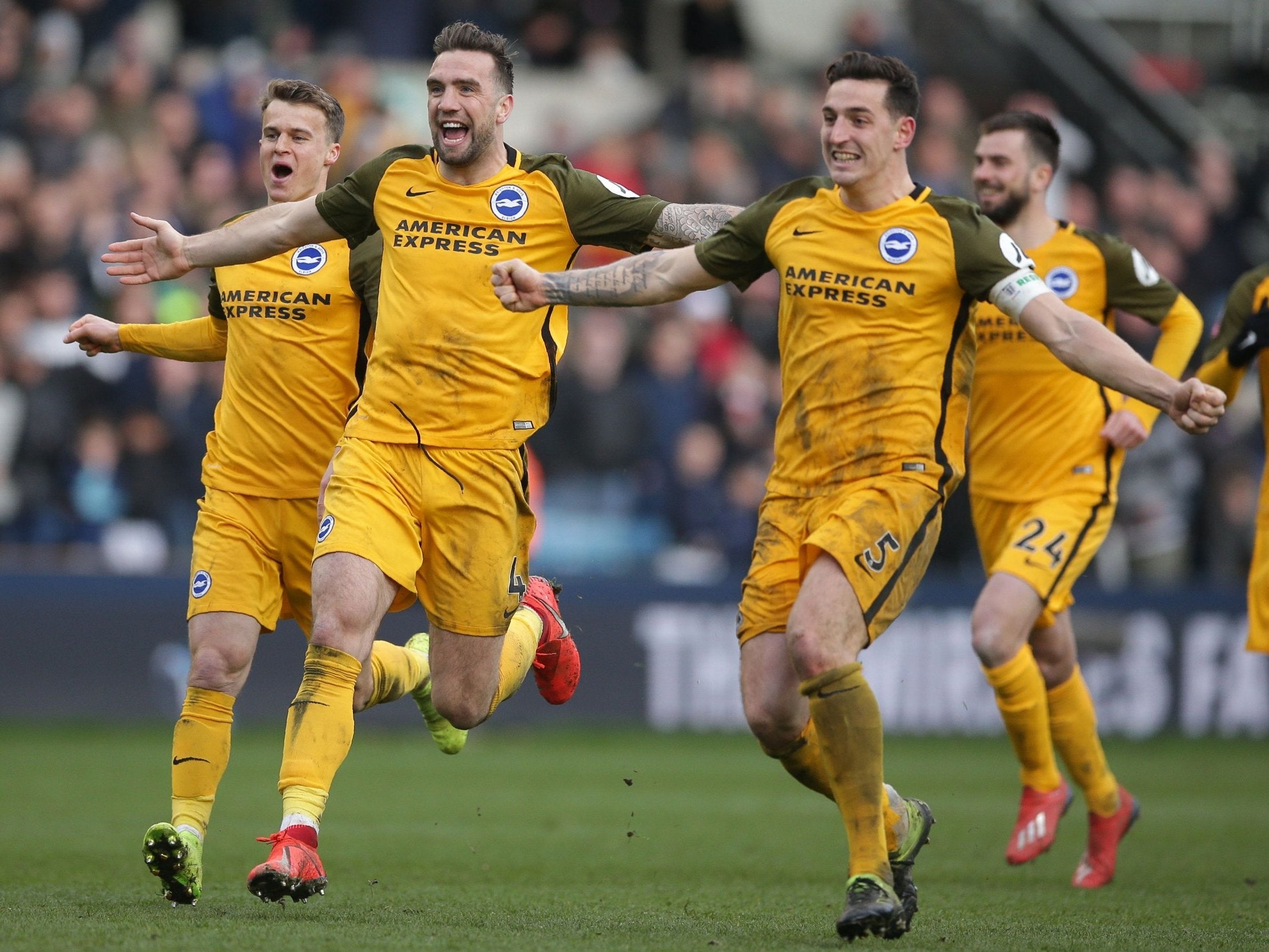 Solly March (L), Shane Duffy (C) and Lewis Dunk (R) celebrate as Millwall's Jake Cooper misses his penalty