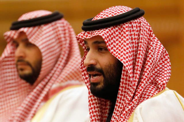 Saudi Crown Prince Mohammad bin Salman, right, speaks to Chinese President Xi Jinping during a meeting at the Great Hall of the People in Beijing