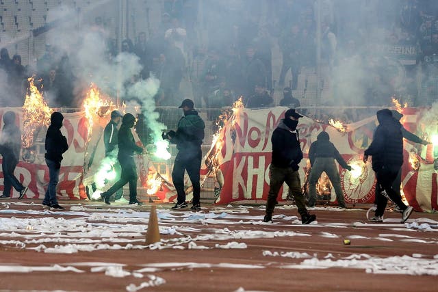 <p>Fans burn a banner in front of stands during a Greek Super League soccer match inside the Athens' Olympic stadium, in Athens, Sunday, March 17, 2019</p>
