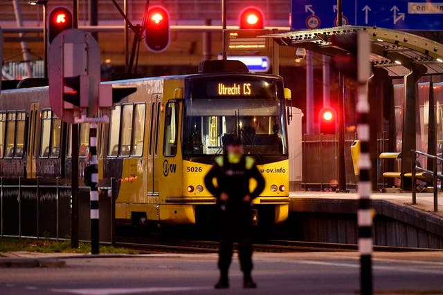A policeman stands guard near a tram where the gunman opened fire
