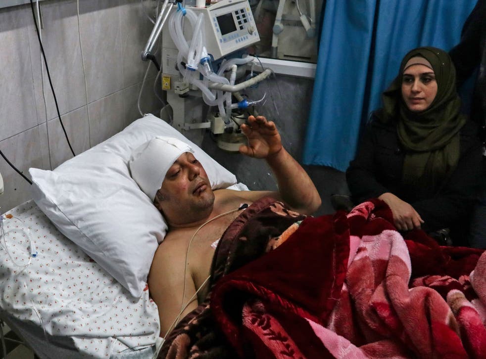 Atef Abu Seif, spokesperson for a Hamas political rival, lies in a hospital bed in Gaza on Tuesday after an attack