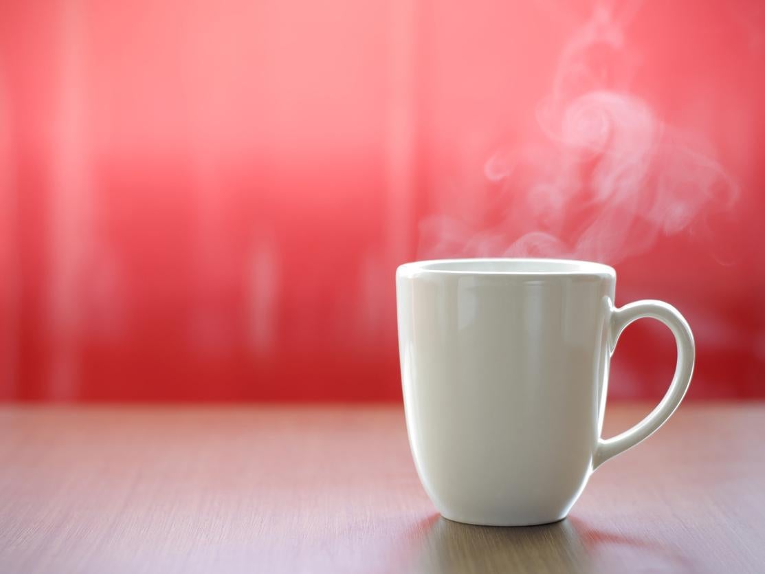 Hot tea in the mug with real smoke ready to drink