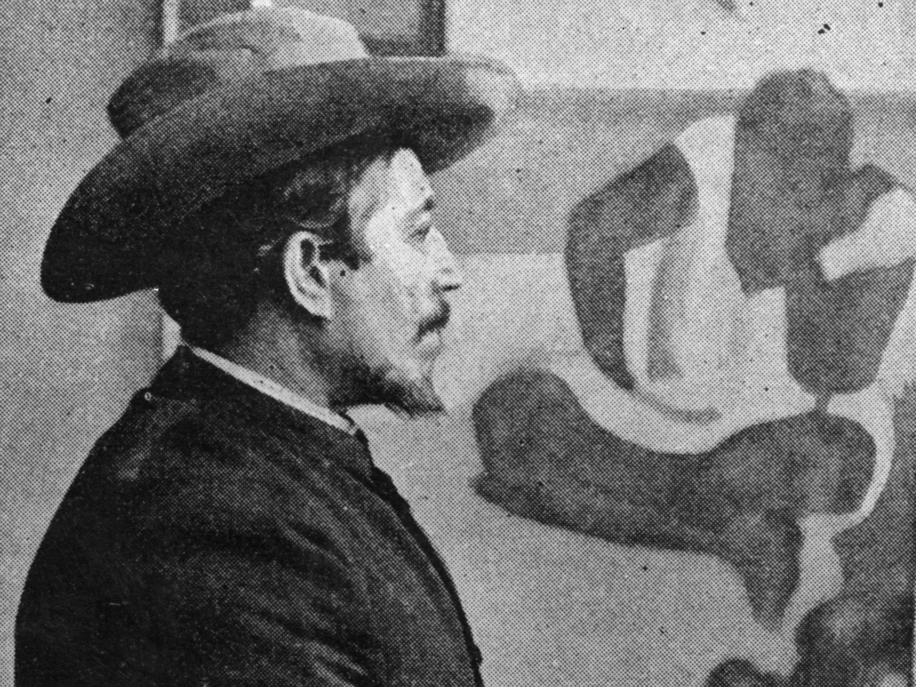 French painter Paul Gauguin (1848-1903) seated in front of one of his paintings