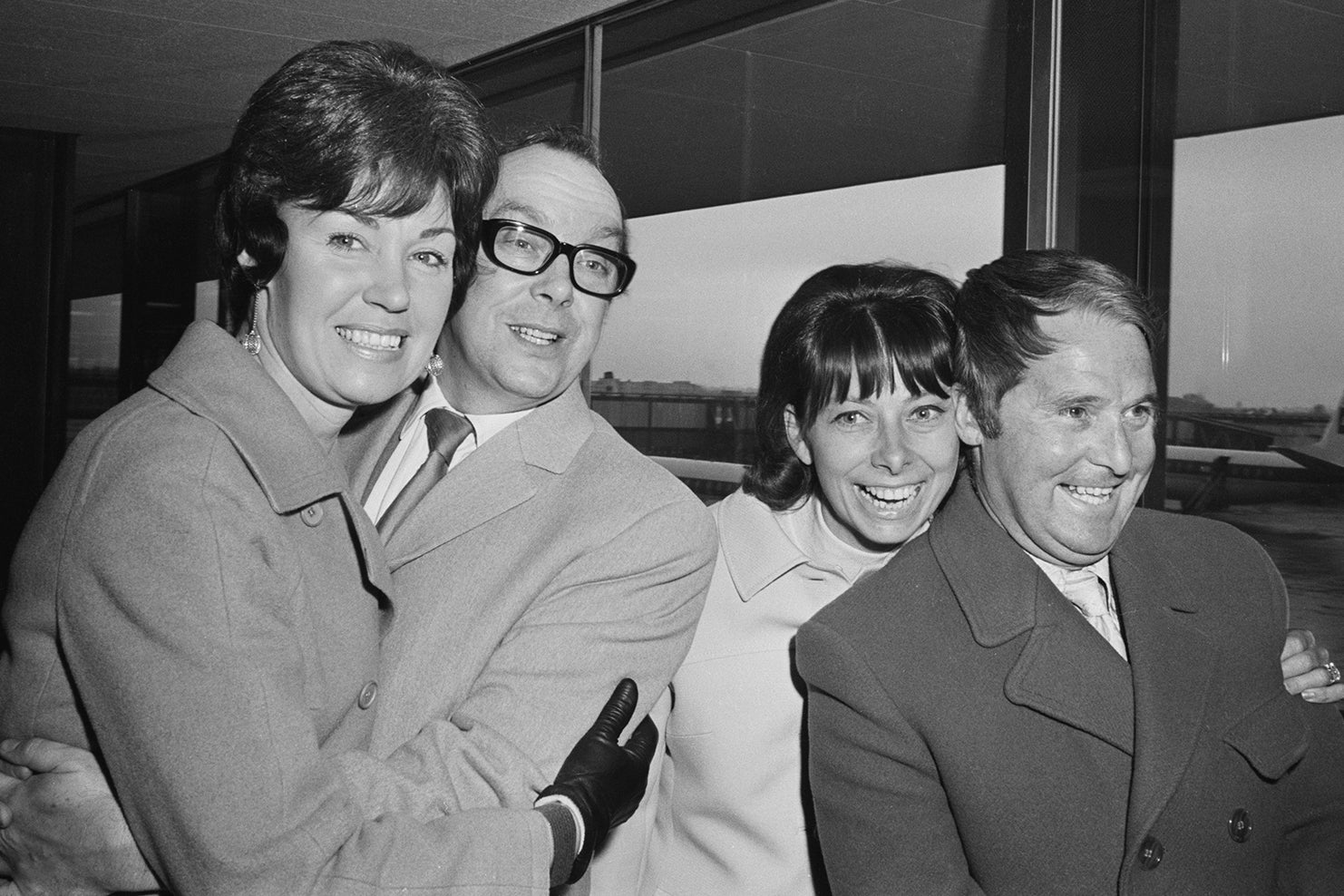 Morecambe and Wise leaving the airport in London with their wives Joan (left) and Doreen in 1970