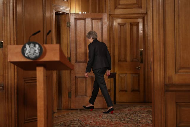 Theresa May leaves after making a statement inside 10 Downing Street