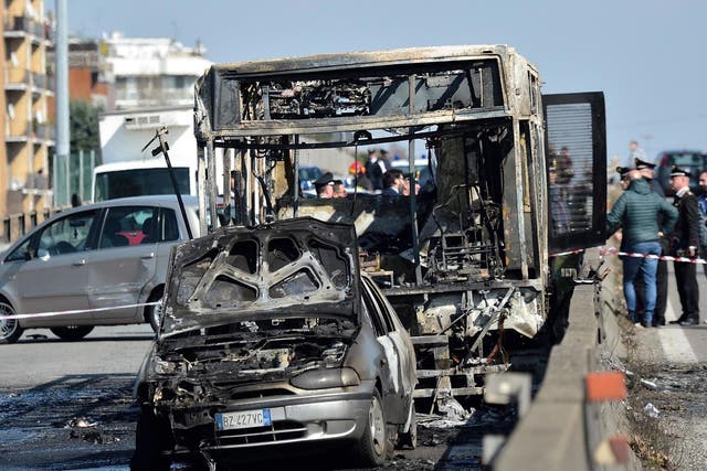 The wreckage of a school bus that was transporting some 50 children after it was torched by the bus' driver, in San Donato Milanese, southeast of Milan