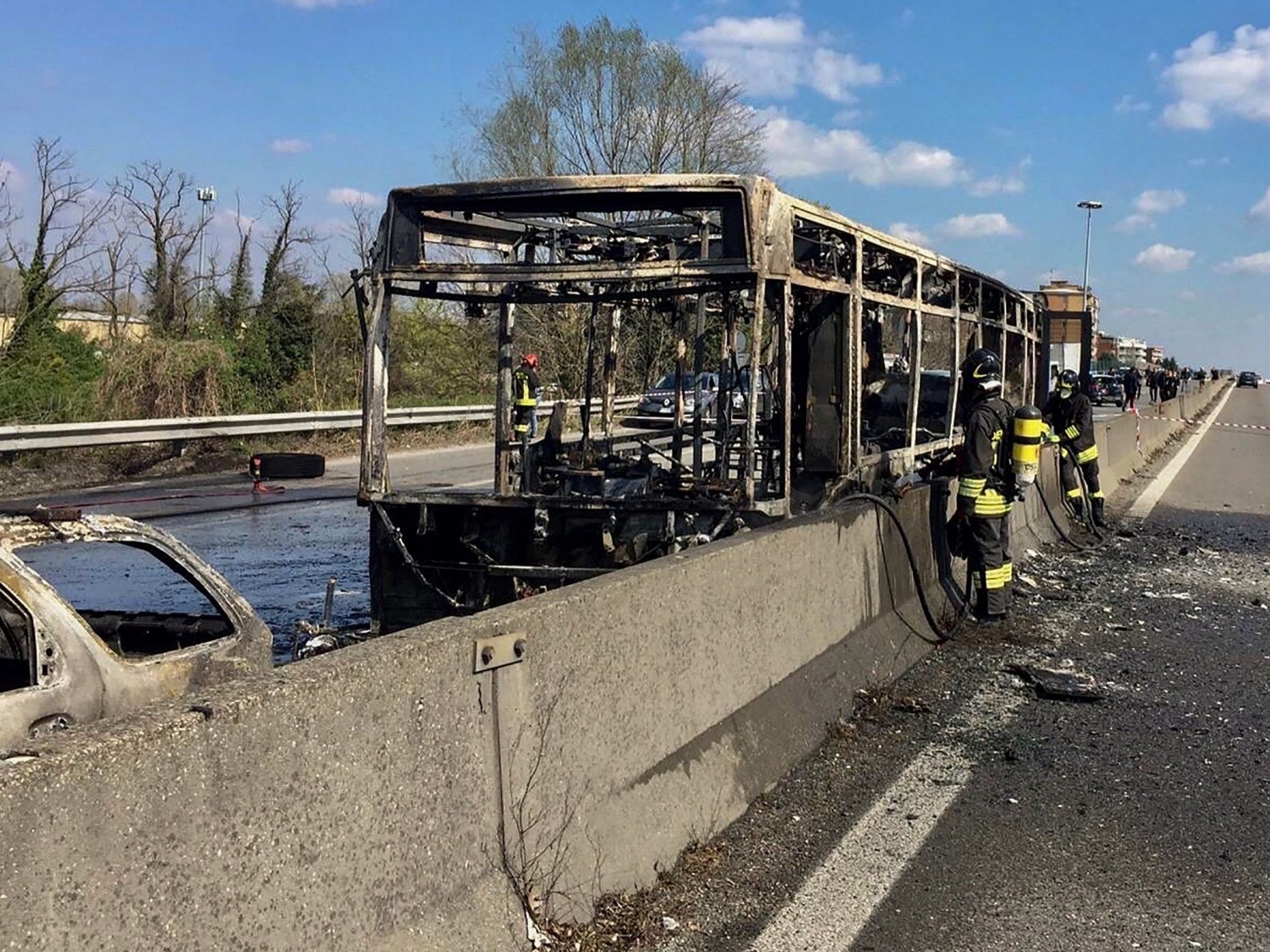 The wreckage of a school bus that was transporting some 50 children after it was allegedly torched by the driver (AFP/Getty)