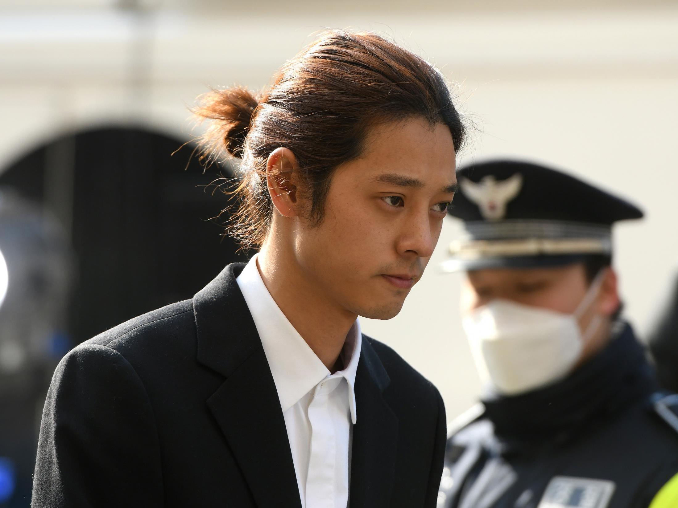 K-pop star Jung Joon-young arrives for questioning at the Seoul Metropolitan Police Agency in Seoul on March 14, 2019