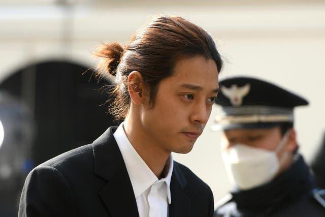 K-pop star Jung Joon-young arrives for questioning at the Seoul Metropolitan Police Agency in Seoul on March 14, 2019