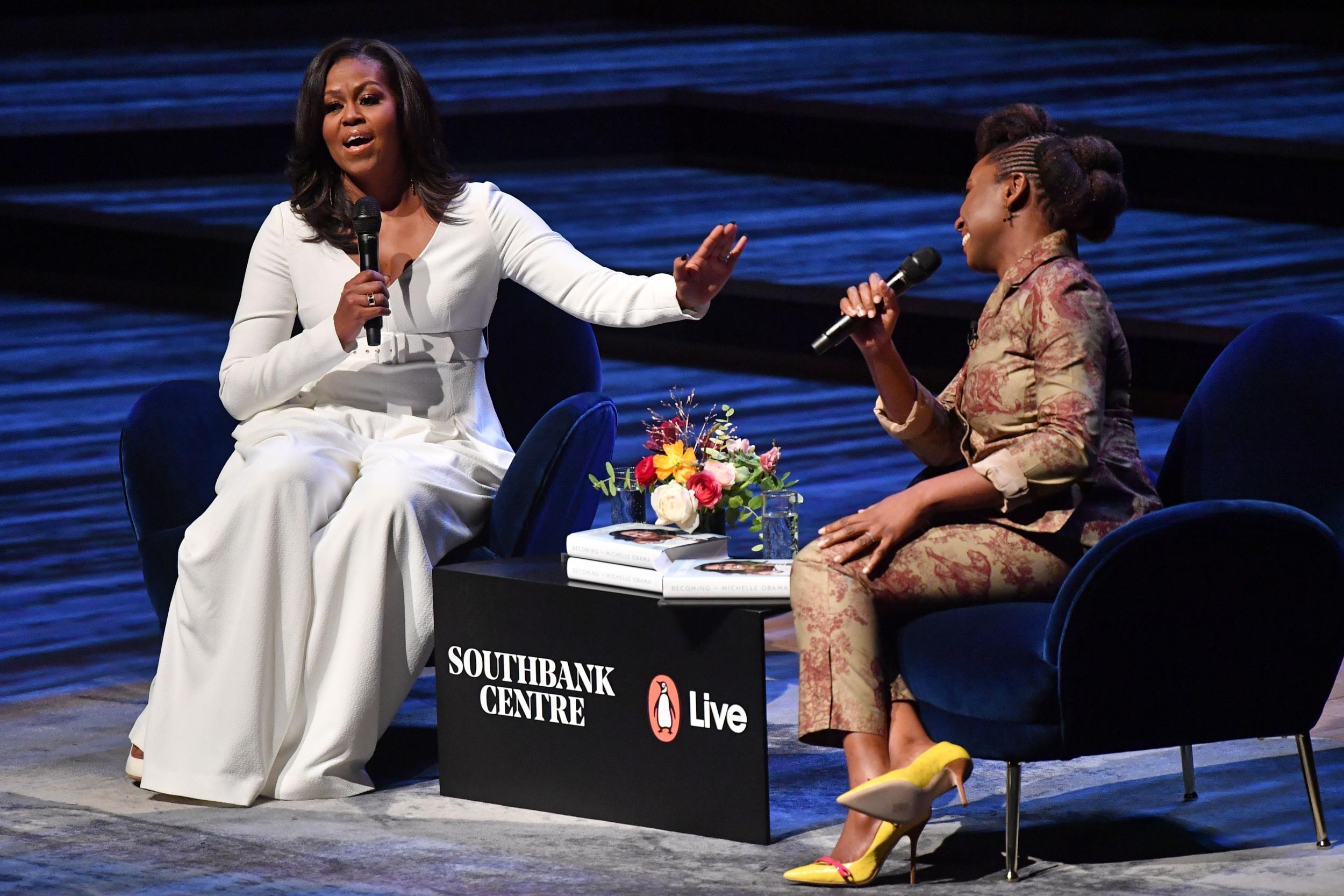 Former US first lady Michelle Obama (L) speaks with Nigerian novelist Chimamanda Ngozi Adichie (R) at the Royal Festival Hall in London on December 3, 2018