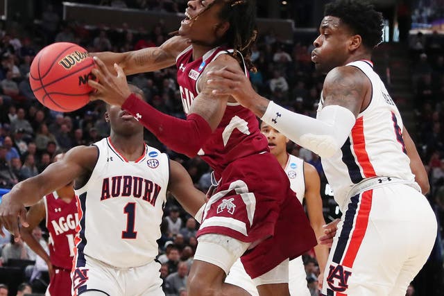 Terrell Brown of the New Mexico State Aggies battles for the ball against Auburn Tigers' Malik Dunbar during the first round of 'March Madness'