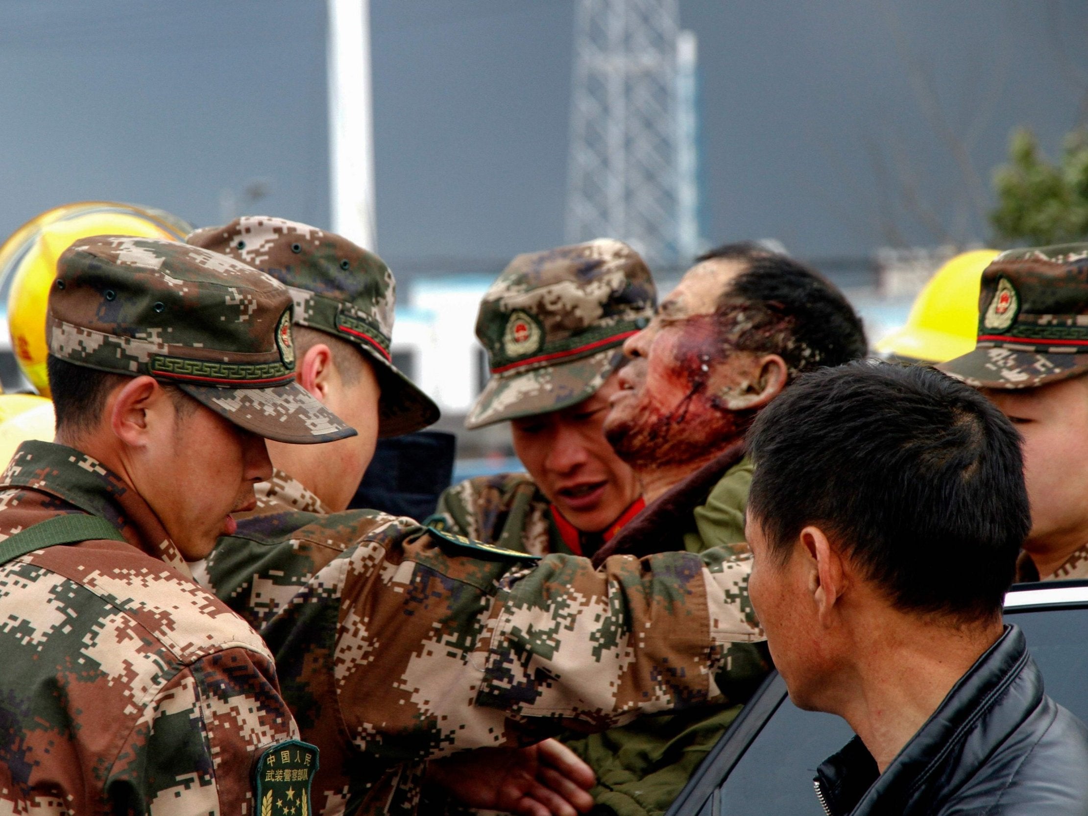 Paramilitary police officers transfer injured man after explosion