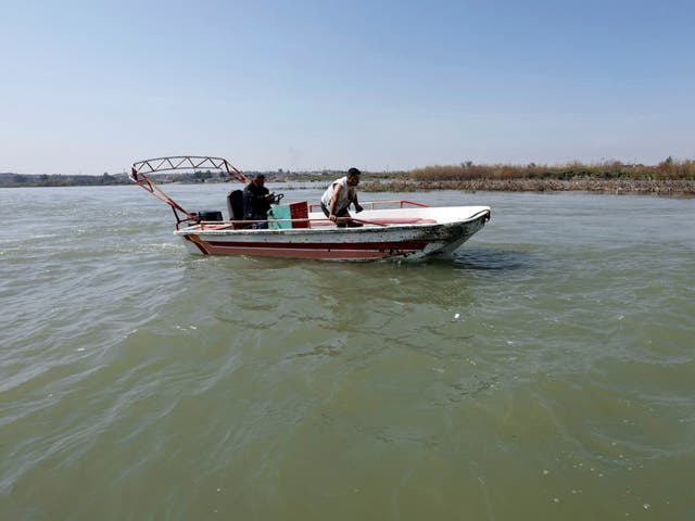 Iraqi rescuers search for victims on the site where an overloaded ferry sank in the Tigris river near Mosul, Iraq, 22 March 2019