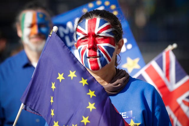 A protester with face painted with the colors of British flag during a protest staged by about 20 anti-Brexit demonstrators calling for a second referendum on Brexit in front of EU Commission Building ahead of EU Summit in Brussels