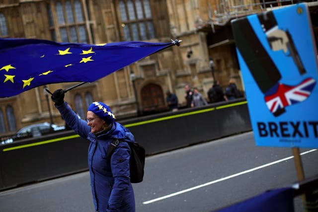 A protester waves an EU flag outside Parliament on Wednesday
