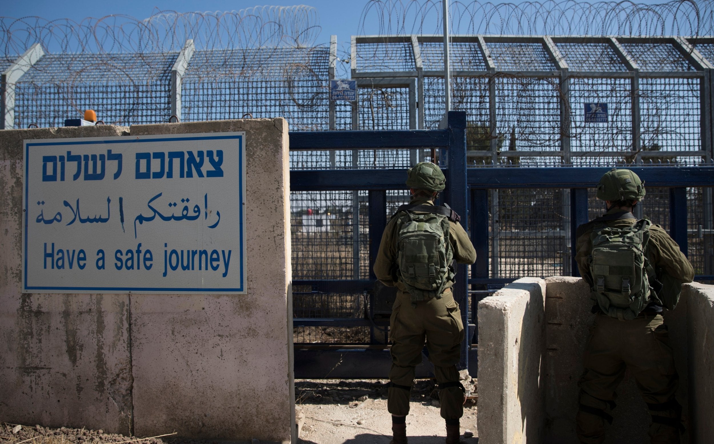 Israeli soldiers stand guard at the Quneitra crossing in the Golan Heights