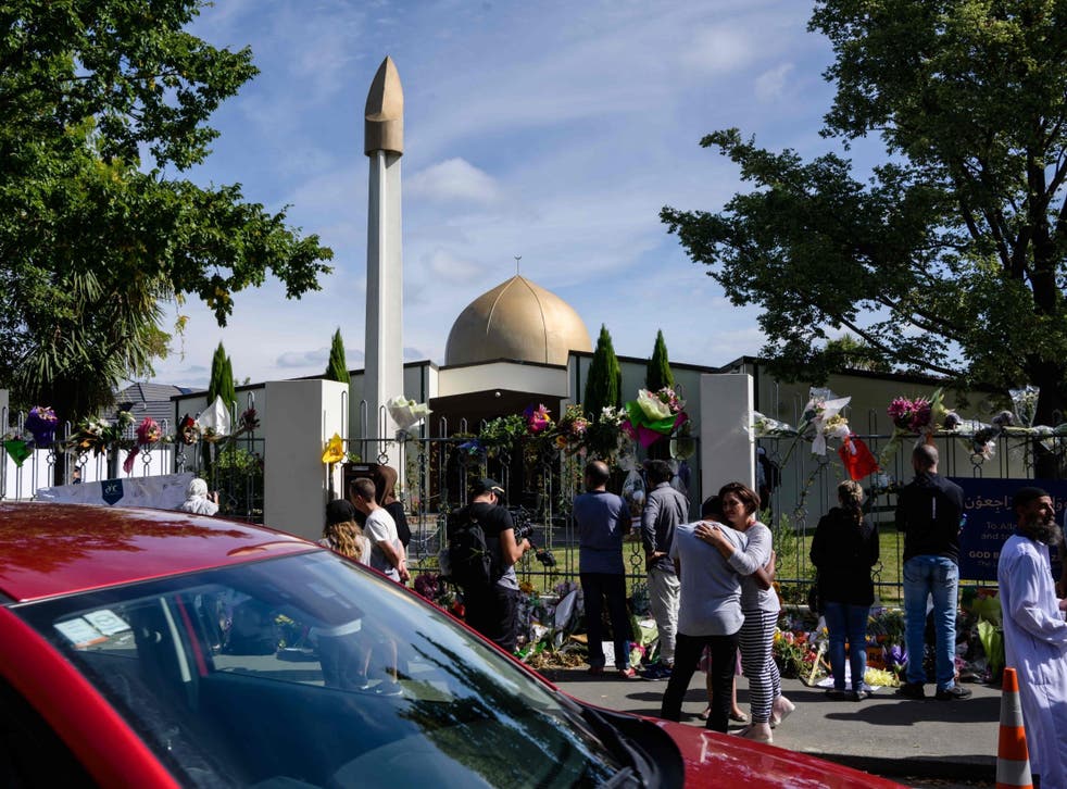 People gather outside the Al Noor Mosque after the main road that runs alongside it was opened to traffic in Christchurch on March 23, 2019. - Muslims prayed at Christchurch's main mosque for the first time since a white supremacist massacred worshippers there as New Zealand sought to return to normality after the tragedy.