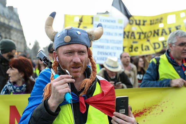 A Yellow Vest protester dressed as a Gaul  takes part in an anti-government demonstration called by the 'Yellow Vest' (gilets jaunes) movement in Paris, on March 23, 2019.  Demonstrators hit French city streets again on March 23 for the 19th consecutive week of nationwide protest against the French President's policies and his top-down style of governing, high cost of living, government tax reforms and for more "social and economic justice."