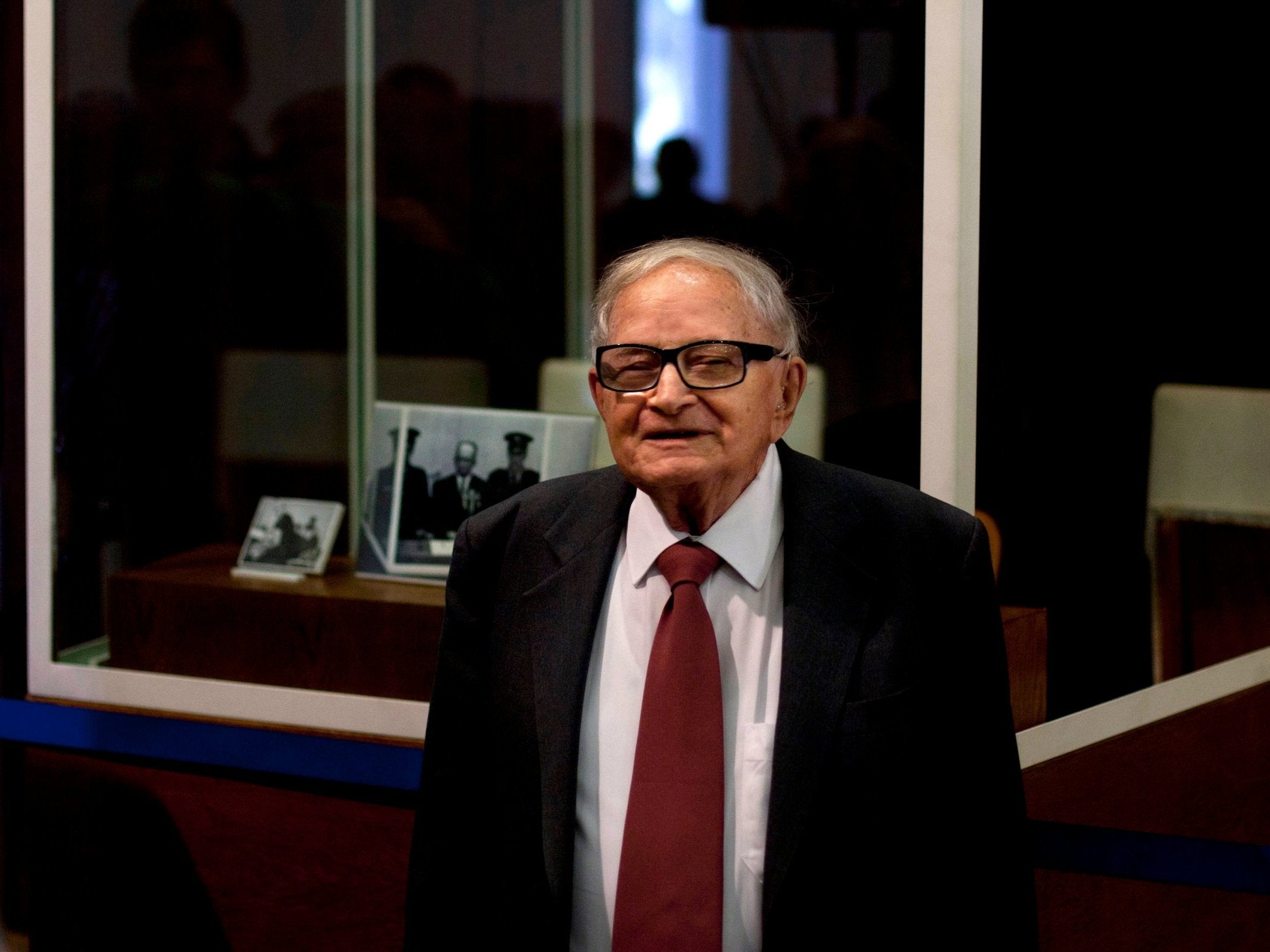 Rafi Eitan stands next to a showcase during an exhibition about Adolf Eichmann’s capture (AP/Sebastian Scheiner)
