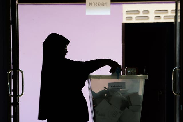 A woman casts her ballot at a polling station in Narathiwat on March 24, 2019 during Thailand's general election.