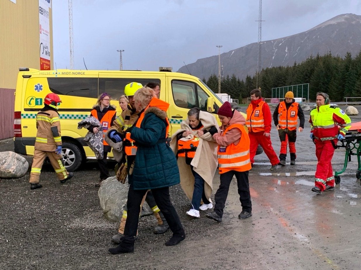 Passengers rescued from the cruise ship are helped from a helicopter into Hustadvika rescue centre