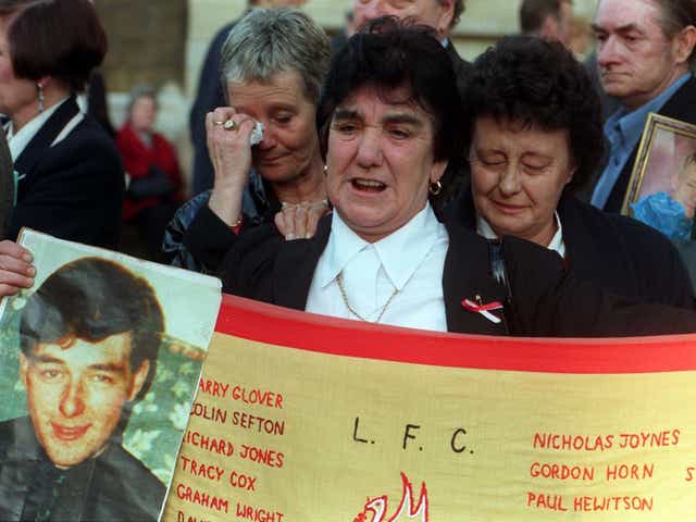 Theresa Glover holds up a photograph of her son, Ian, who died at the age 20