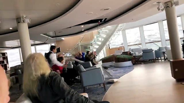 Passengers protect themselves from a collapsing ceiling as the cruise ship Viking Sky lists