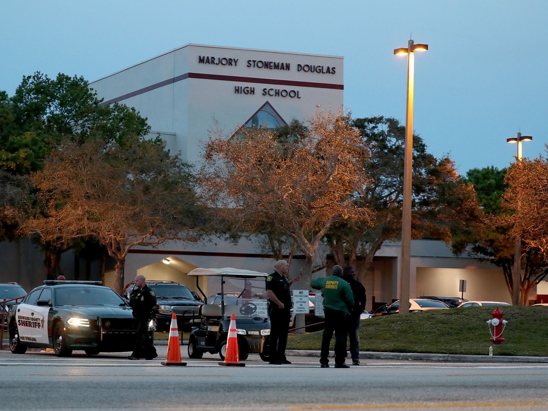Police officers stand outside Marjory Stoneman Douglas High School on the one year anniversary of the shooting