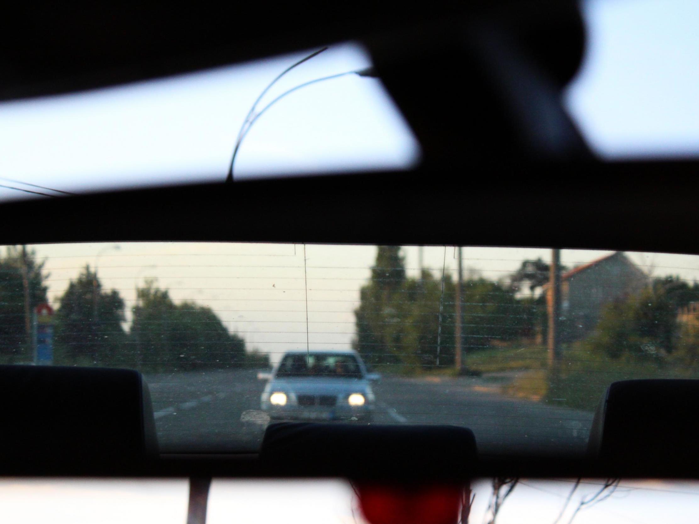 File image of car in rear view mirror.