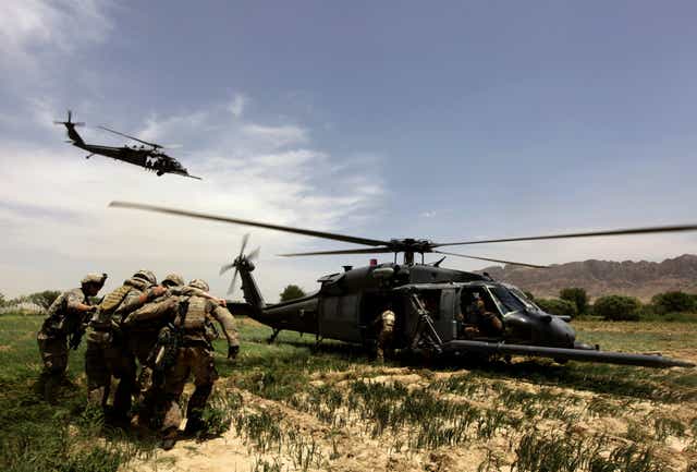 U.S. Army specialist helped by comrades into a Black Hawk helicopter during a medical evacuation operation near the Arghandab river in Kandahar province, southern Afghanistan
