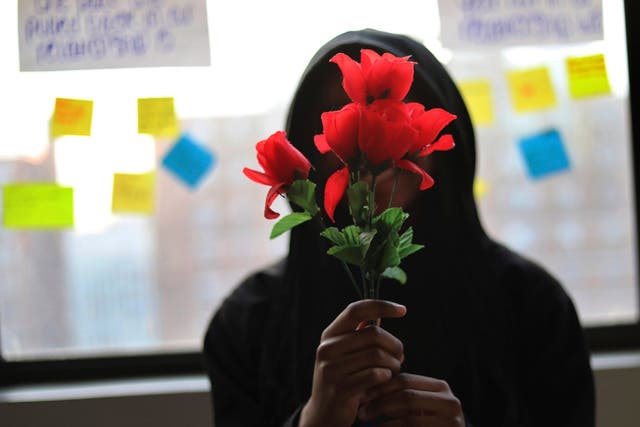 Sexual assaults and harassment on flights had started getting increased attention thanks to the #MeToo movement. Pictured: A survivor of sexual assault holds plastic flowers after attending a meeting with the group "Sisters in Strength" in the Brooklyn borough of New York on Thursday 14 March 2019.