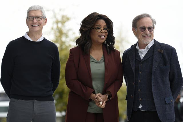 Apple CEO Tim Cook, Oprah Winfrey and filmmaker Steven Spielberg pose for photos during an Apple product launch event at the Steve Jobs Theatre on 25 March, 2019 in Cupertino, California.