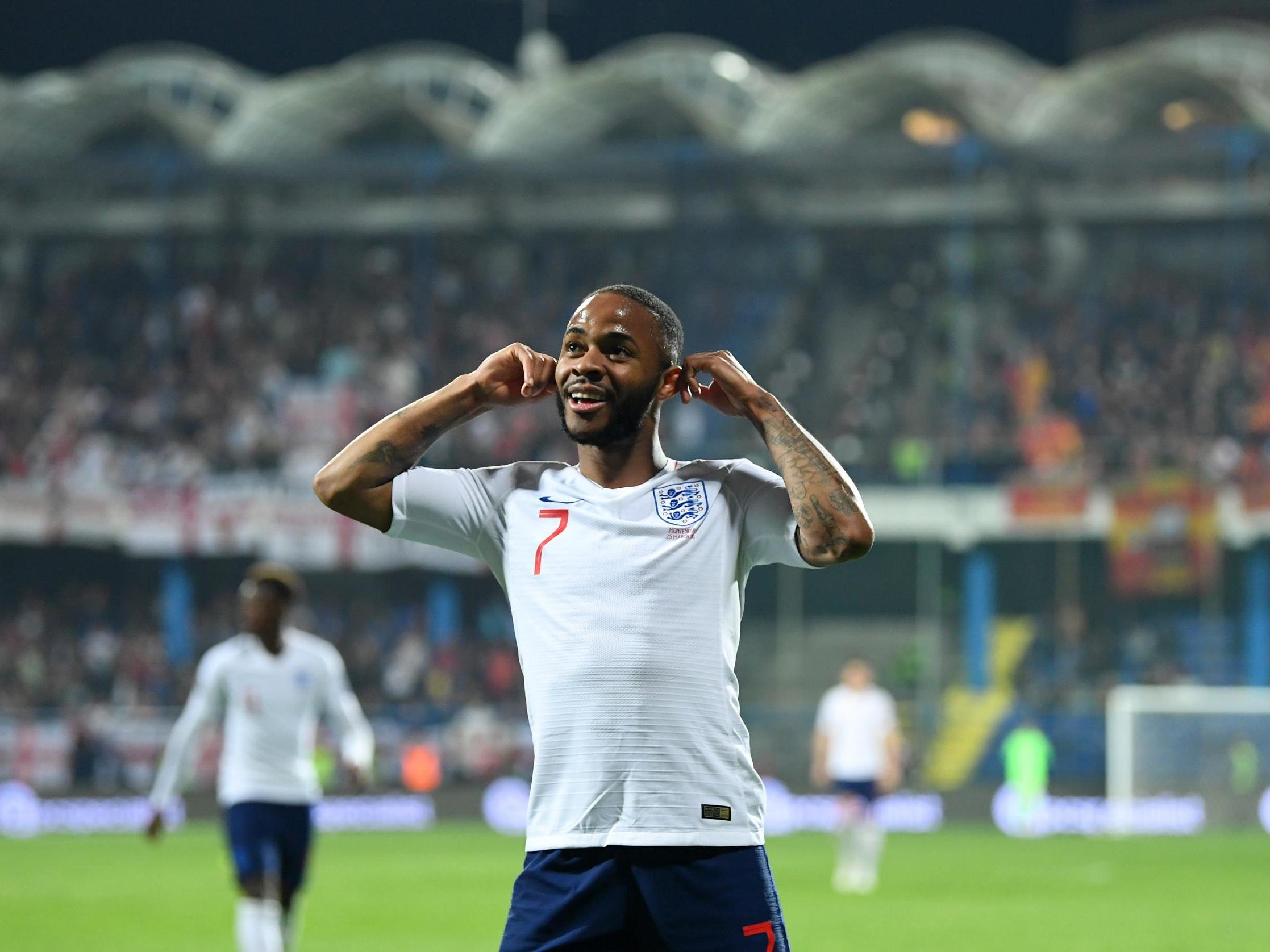 The England forward Raheem Sterling gestures towards the home fans