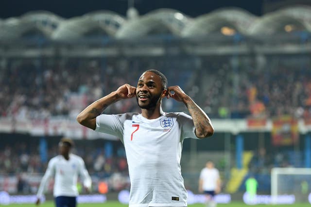 The England forward Raheem Sterling gestures towards the home fans