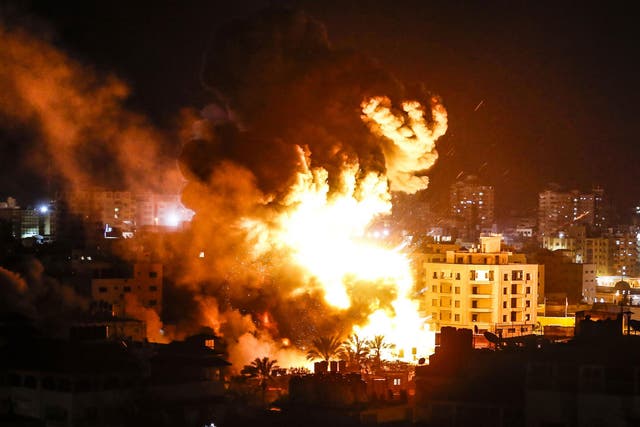 Fire and smoke billow above buildings in Gaza City during reported Israeli strikes on March 25