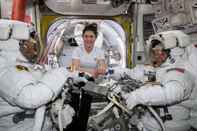 NASA astronaut Christina Koch (centre) assists fellow astronauts Nick Hague (left) and Anne McClain in their US spacesuits shortly before they begin a spacewalk