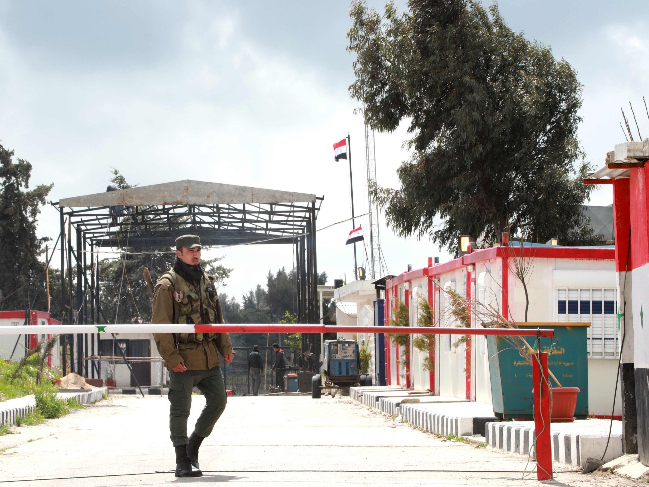 A member of the Syrian security forces stands guard at a border post in the Golan Heights