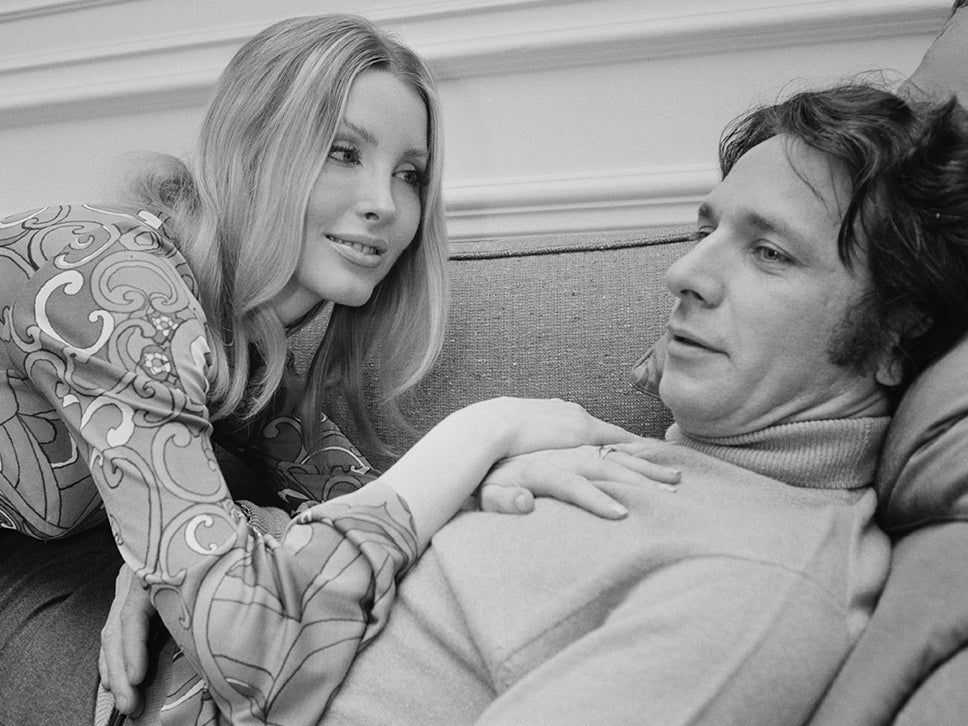 The French composer and conductor with his wife, American actress Laura Devon, in 1968